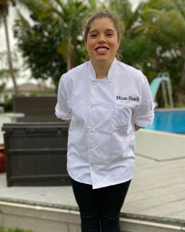 Mica — personal chef and owner of Mica's Shack, posing in a professional kitchen setting in Miami, FL